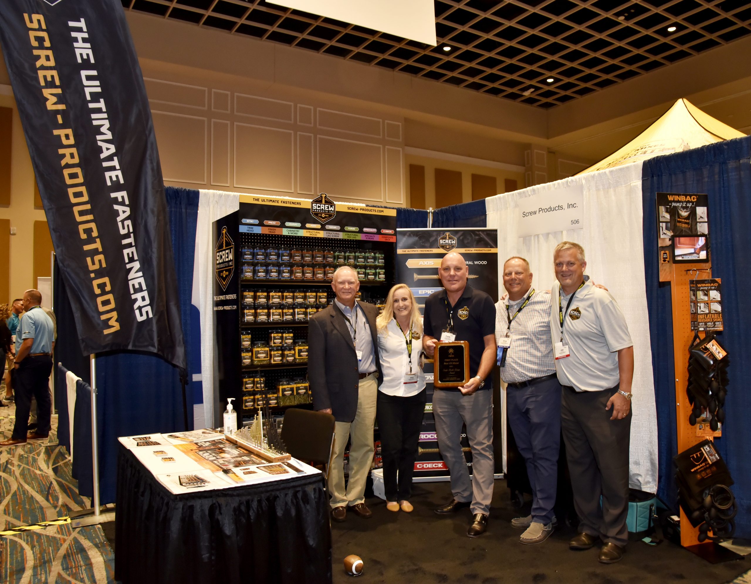 Scew Products Inc. accept an award at a FBMA event